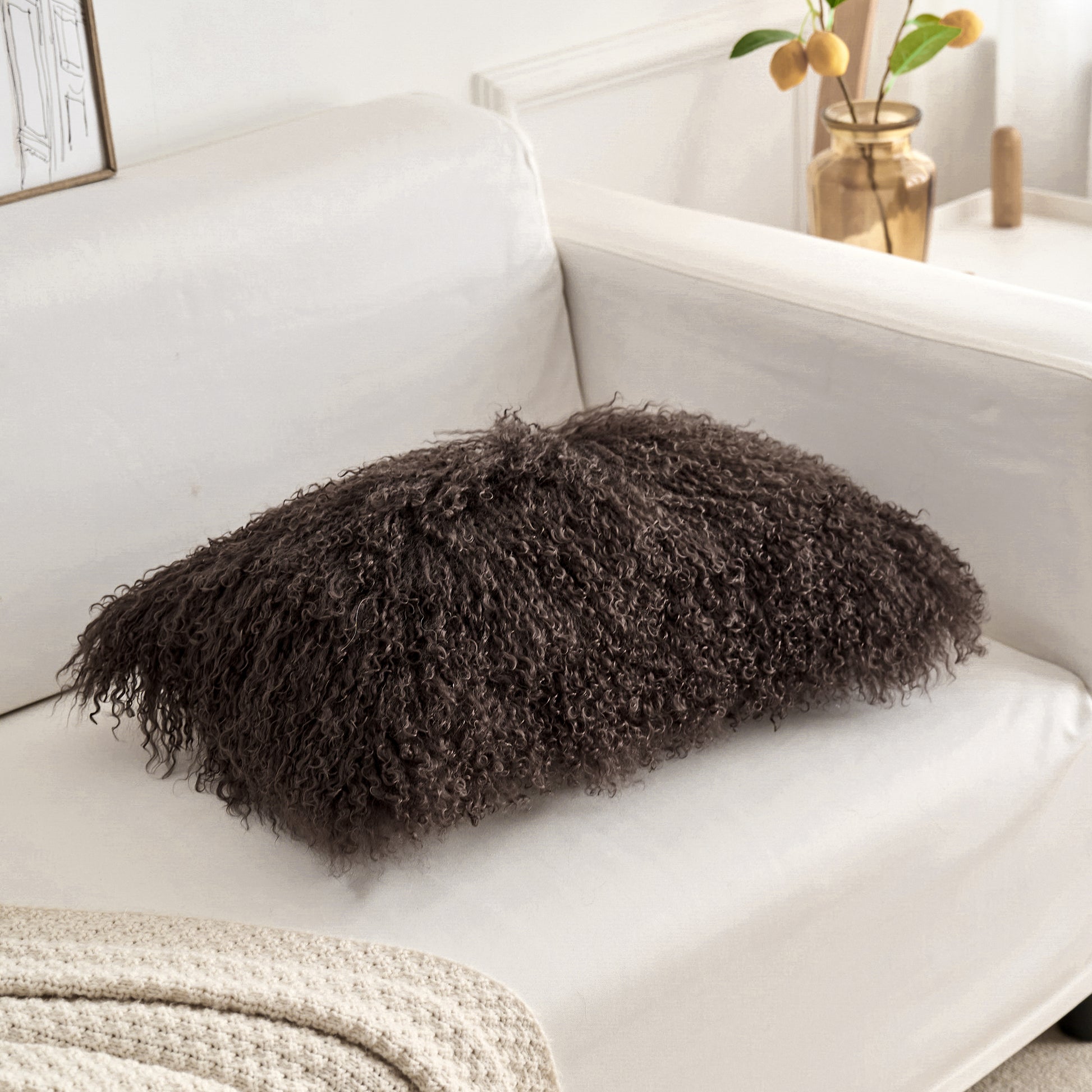 Chocolate Brown fuzzy fur pillow in an organic modern interior with a lounge chair