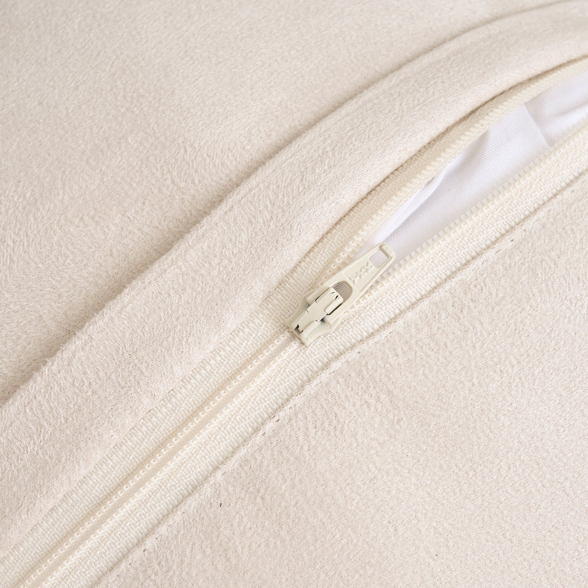 Close-up of cushion back made with suede fabric showing premium soft texture and YKK zipper detail for secure closure and high-quality craftsmanship in beige