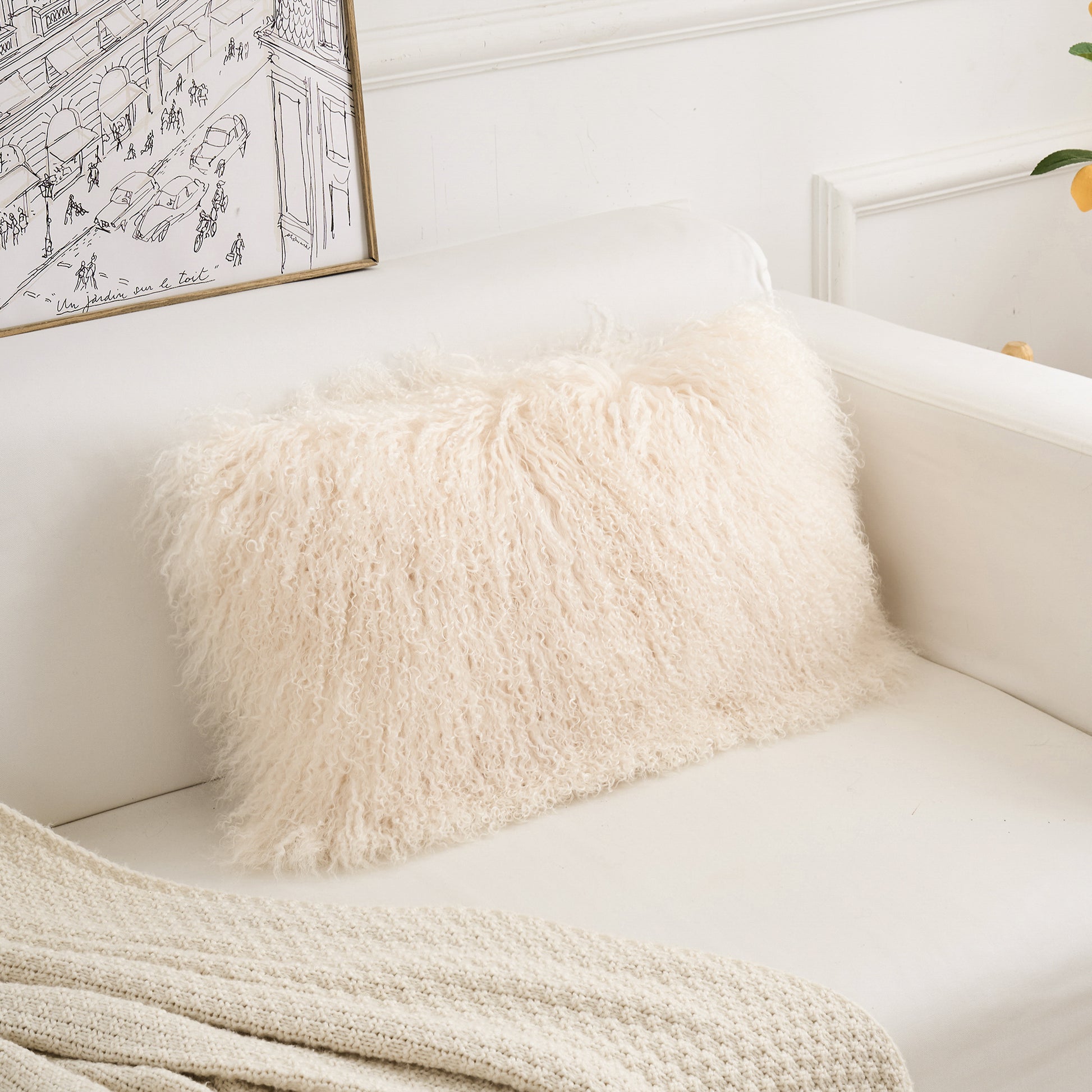 Mongolian lamb fur lumbar pillow styled in a modern neutral living room