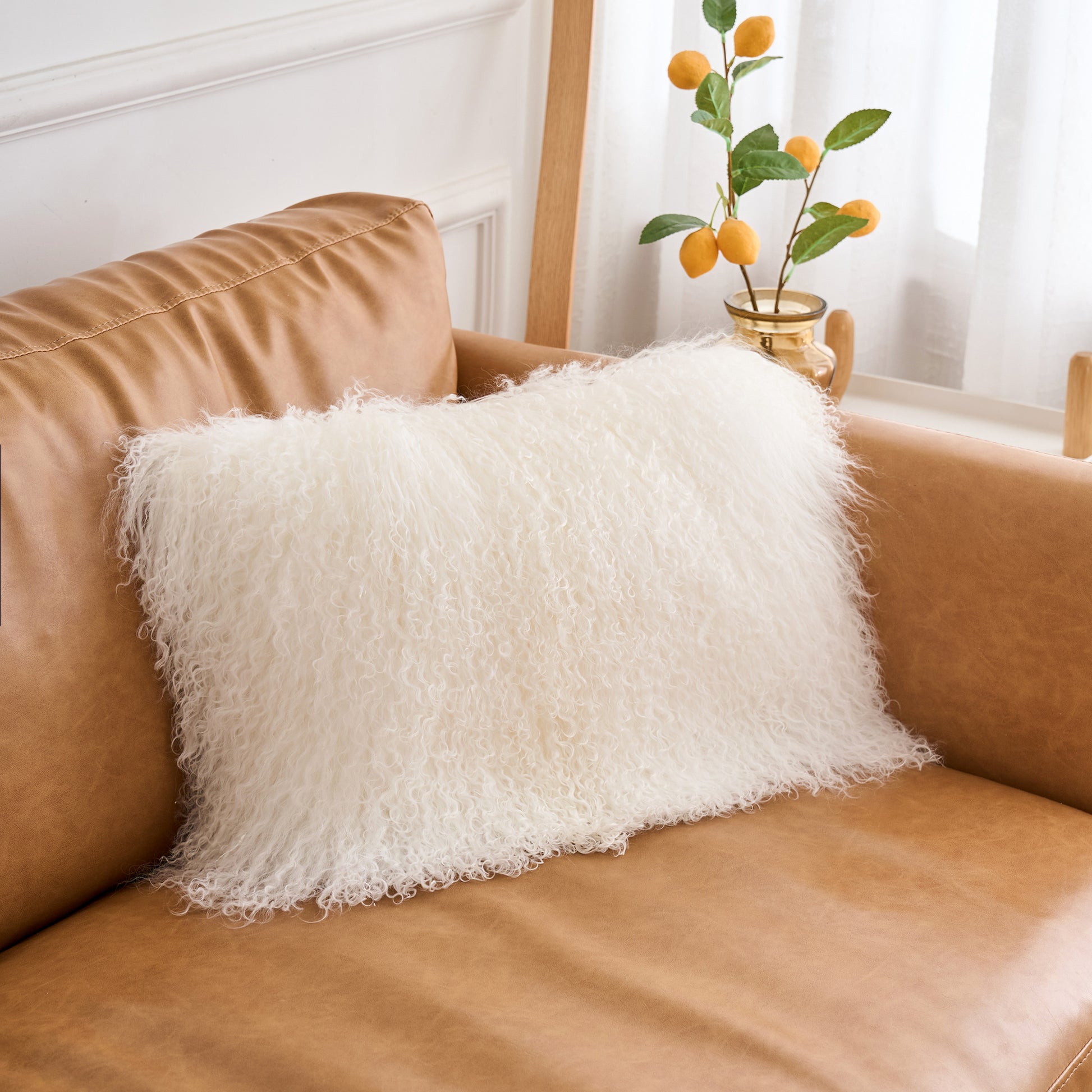 Mongolian lamb fur lumbar pillow styled on a modern sofa