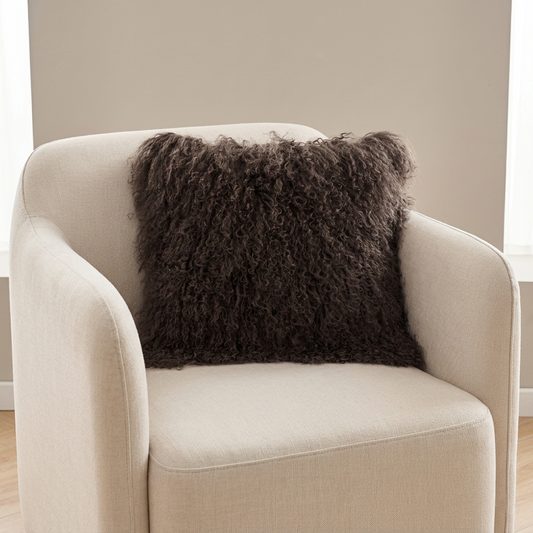 Mongolian lamb fur pillow in Espresso Brown with soft curly wool texture placed on a single sofa in modern luxury living room