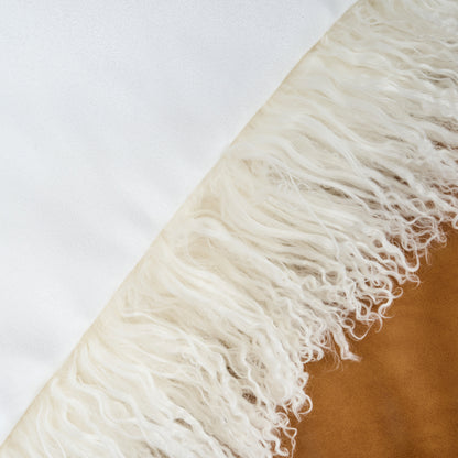 Close-up detail of Mongolian lamb fur pillow in natural white with soft dense curly wool texture showing natural luxury fiber quality
